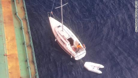The cargo ship, headed for Newcastle, Australia, came to the assistance of the yacht.