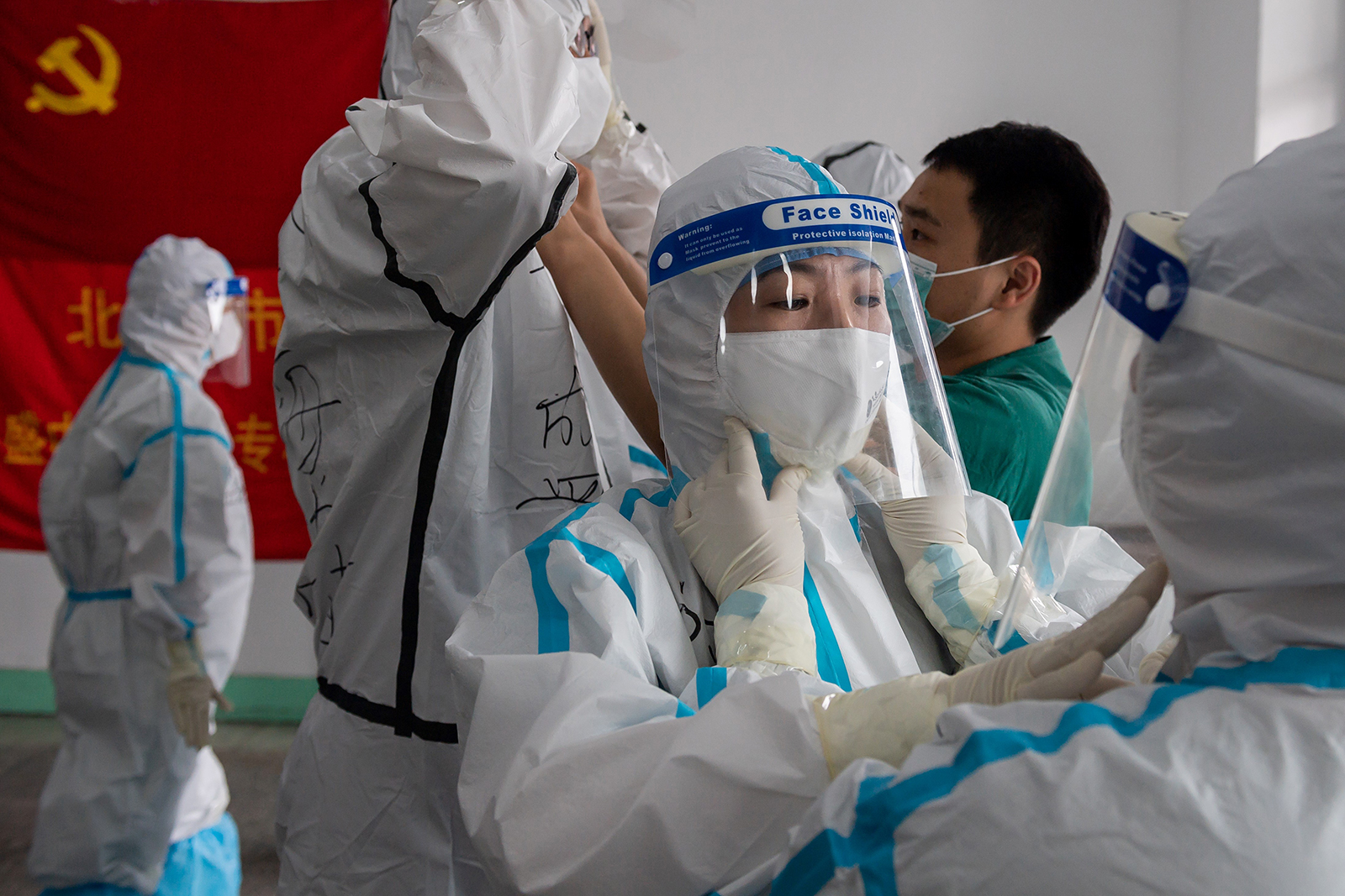 Medics prepare for their shift at the Jinrong Street testing site, in Beijing on June 24.