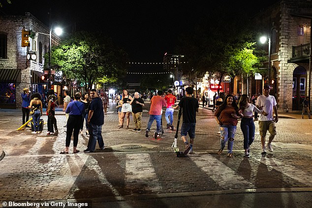 People gather on Sixth Street in downtown Austin, Texas on May 23. Bars have now closed