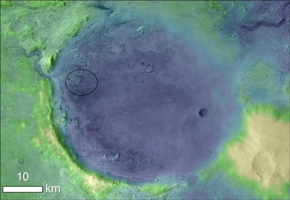 Jezero Crater on Mars, the landing site for NASA's Mars 2020 mission. The oval indicates the landing ellipse, where the rover will be touching down on Mars. The color added to this image helps the crater rim stand out clearly, and makes it easier to spot the shoreline of a lake that dried up billions of years ago.