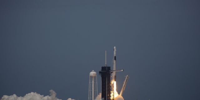 The SpaceX Falcon 9 rocket launches into space from Kennedy Space Center with NASA astronauts Bob Behnken and Doug Hurley aboard the Crew Dragon spacecraft on May 30, 2020.