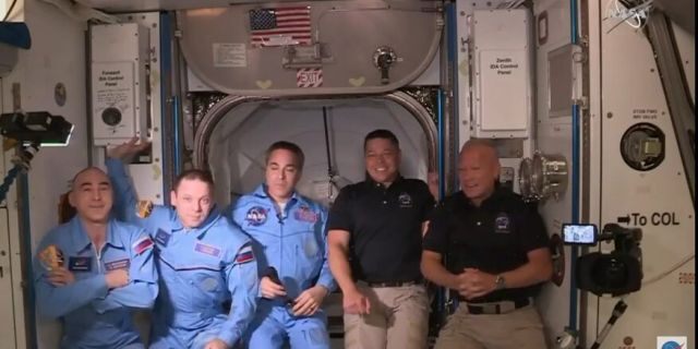NASA astronauts Doug Hurley (right) and Bob Behnken (second right) after boarding the International Space Station, where they were welcomed by fellow astronaut and Expedition 63 Commander Chris Cassidy (center) and Russian cosmonauts Anatoly Ivanishin (left) and Ivan Vagner (second left).