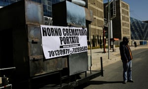A man stands near the prototype of a mobile crematorium with a banner reading “Mobile crematorium, Made in Bolivia”, built by a local engineer to alleviate the backlog of bodies at local crematoriums, in La Paz, Bolivia 4 August 2020.