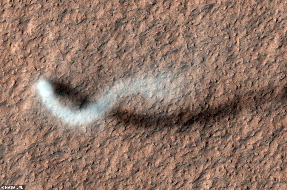 As HiRISE pans over large swaths of Mars' surface, it occasionally discovers surprises like this towering dust devil, which was captured from 185 miles (297 kilometers) above the ground