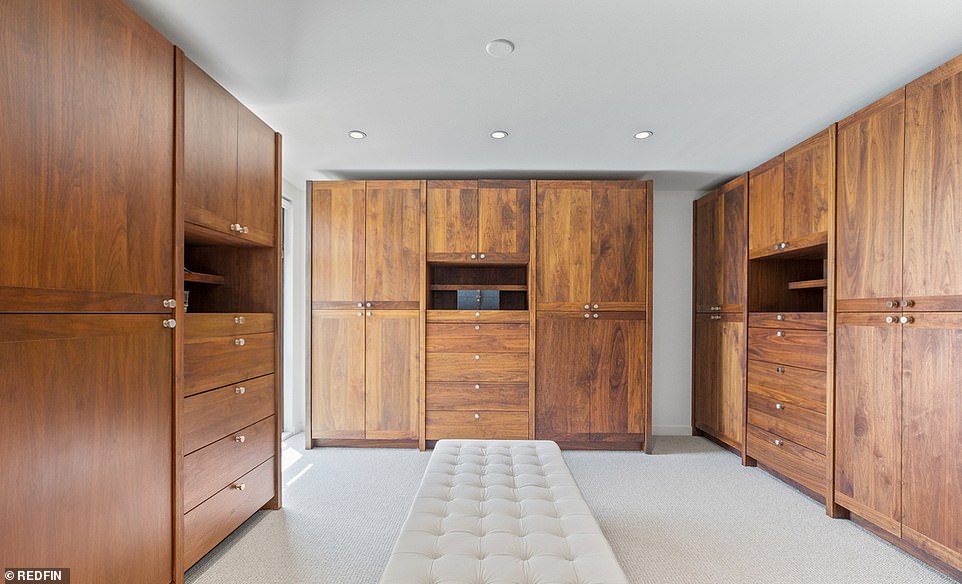 Closet space: The beautiful master suite spans the width of the house, featuring its own sitting room, a vast dressing room with wooden wardrobes and a luxurious bathroom