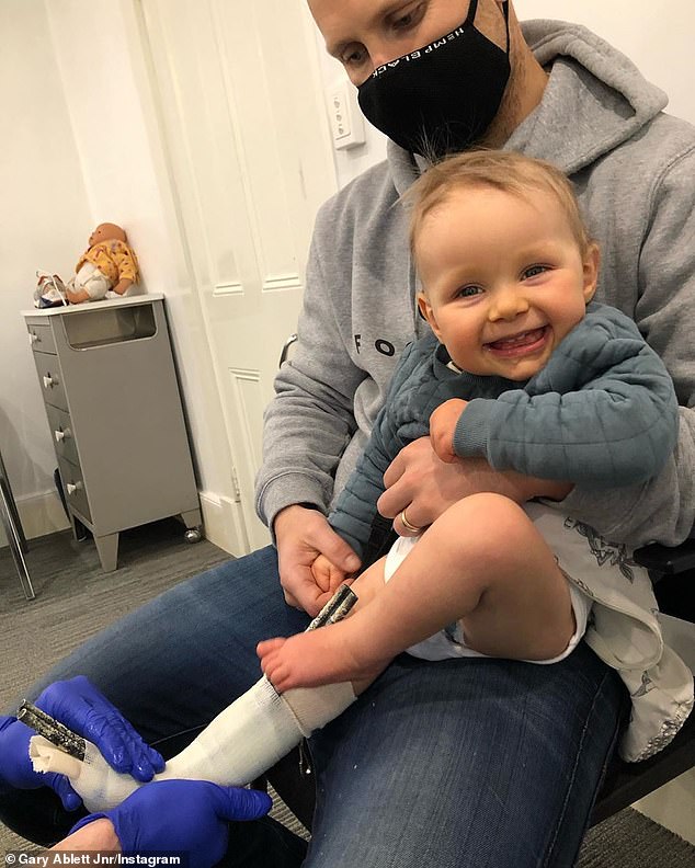 The Geelong Cats midfielder posted the image of a smiling 19-month-old Levi on Instagram on Wednesday that showed the youngster being fitted with a medical boot (pictured)