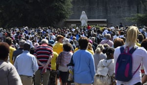 Worshippers leave after attending the Sunday mass in front of a reduced number of faithfuls due to sanitary measures, in the Saint Pie X Basilica in Lourdes, on 15 August, 2020, as part of the 147th Assumption pilgrimage.