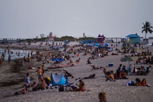 People relax on the beach in Miami Beach, Florida amid the coronavirus pandemic 28 July, 2020. The US corornavirus tally reached 5,000,603 cases on Sunday morning and 162,430 deaths - both totals by far the highest of any country in the world.