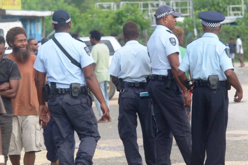 Police officers monitor a town in Oki, Solomon Islands.