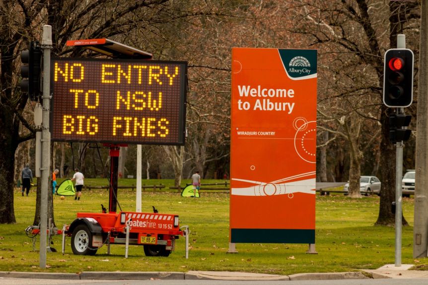 A sign saying No Entry to Large NSW Fines Next to a Sign Saying Welcome to Albury.