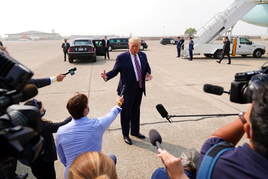 Donald Trump speaks to reporters at the airport terminal.