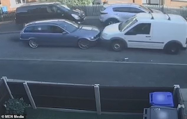 A white Ford Transit van and a gray BMW close together on the narrow road in Dunkinfield, Greater Manchester, and refuse to prioritize