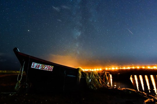 Vladivostok, Russia?  October 10, 2018: A meteor breaks through the night sky over Rusky Island during the Draconid meteor shower.  Yuri Smituk / TASS