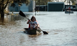 Residents paddle in a neighborhood inundated after Hurricane Delta passes over Delcumber, Louisiana