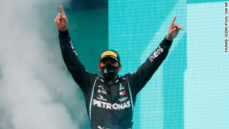 Hamilton celebrates on the podium after winning the Turkish Grand Prix.