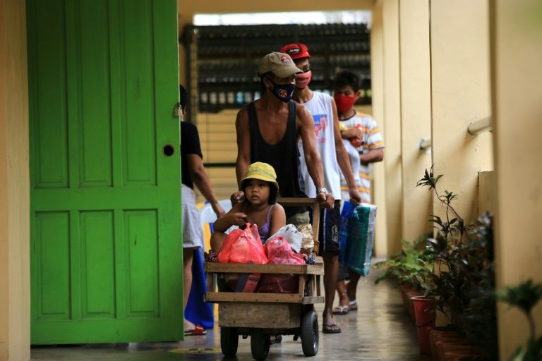 Residents fleeing Super Typhoon Goni arrive at an evacuation center in Legazpi south of Manila -- nearly a million people have left their homes ahead of the storm's arrival