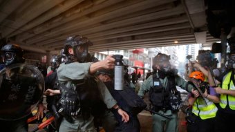 Hong Kong police use pepper spray on protesters protesting China's new national security laws.