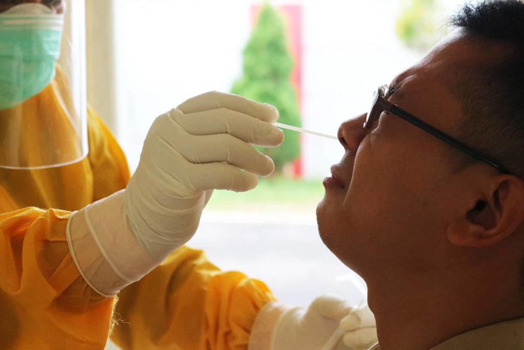 Testing for COVID-19 involves a nasopharyngeal swab. The swab is inserted into the patient’s nose and is aimed in a parallel direction to the nasal and septum floor. Photo: Mufid Majnun on Unsplash