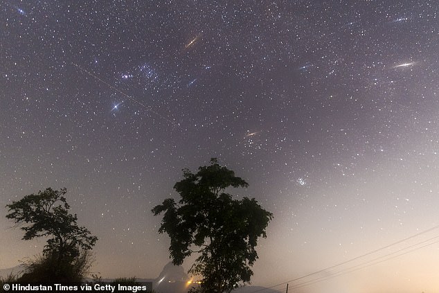 More than 100 multicolored stars are scheduled to spread across the night sky this weekend during the peak of the Geminid meteor showers.  Pictured is the Geminid meteor showers seen from Lake Bauna near Lonavala on December 14, 2017 in Mumbai, India