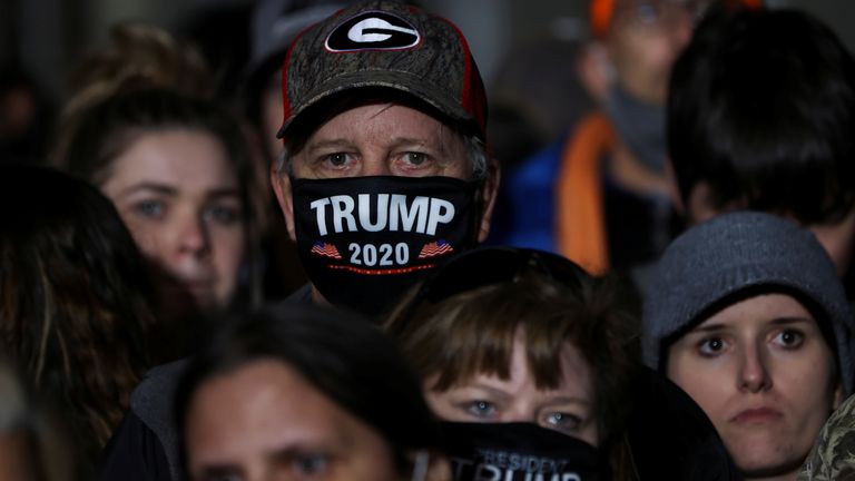 A man wears a Trump 2020 face mask at a rally in Valdosta, Georgia