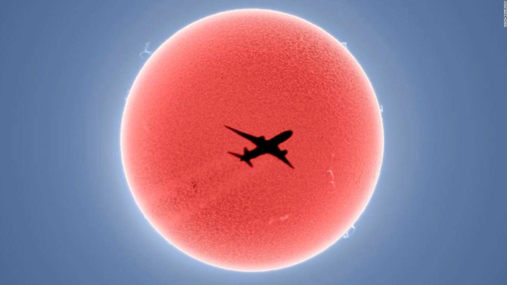The moment the plane passes over the sun