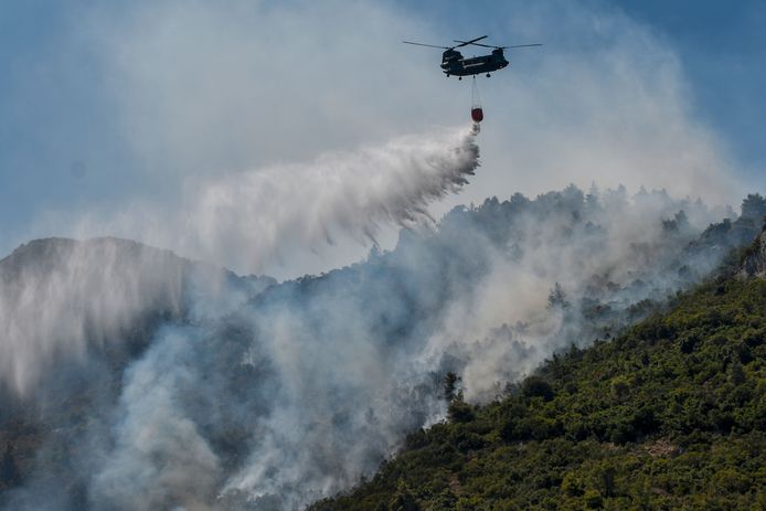 A Chinook helicopter drops water on a forest fire near Malakasa, north of Athens.