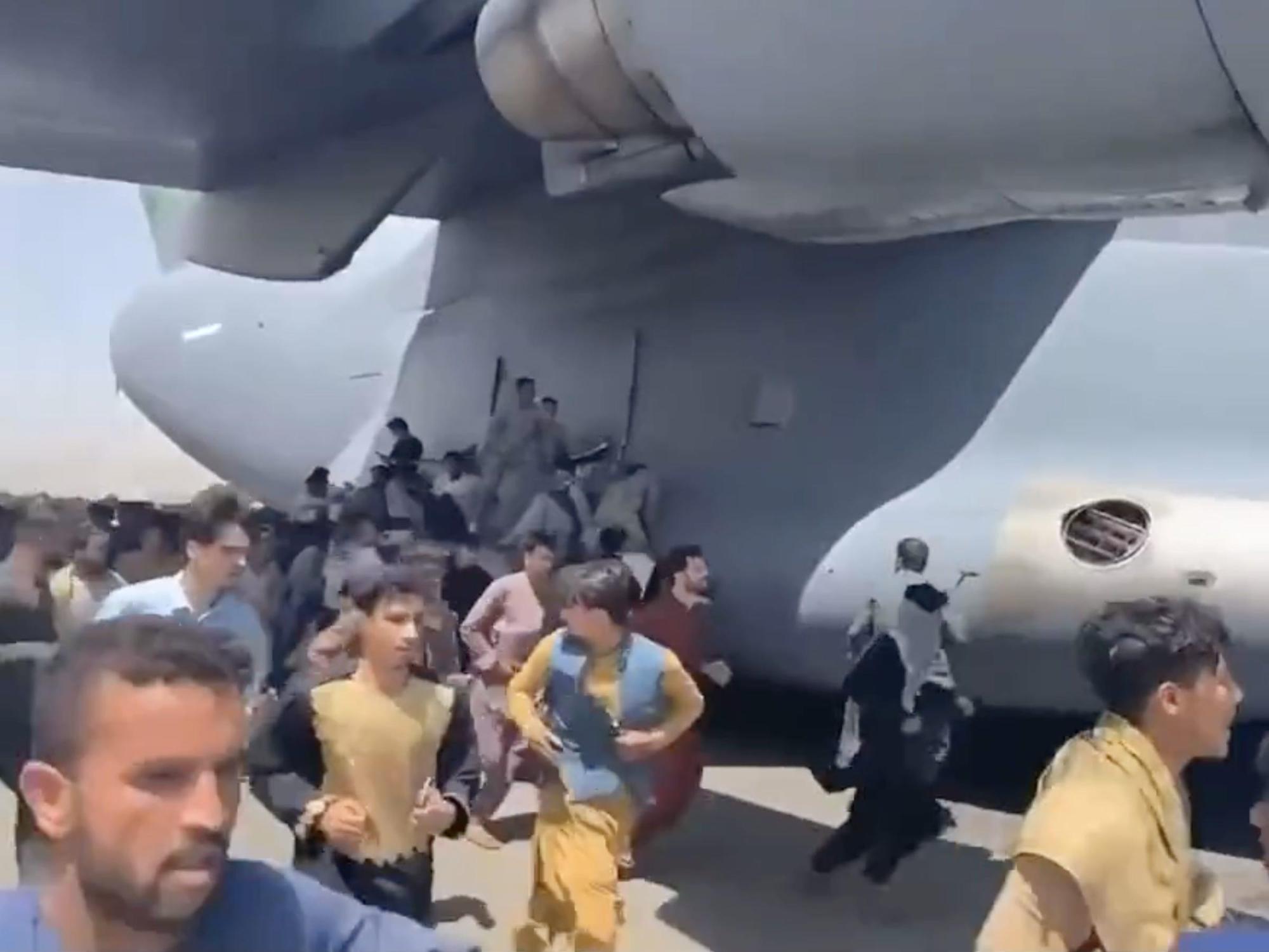 Video shows people clinging to a US Air Force plane at Kabul airport as they desperately try to flee Afghanistan