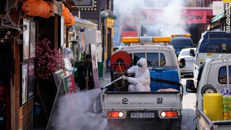 On Friday, October 29, a local health official wearing safety clothing in Seoul, South Korea, disinfected storefronts as a precaution against the coronavirus.