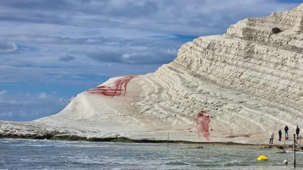 A famous Italian cliff was defaced with red powder by vandals