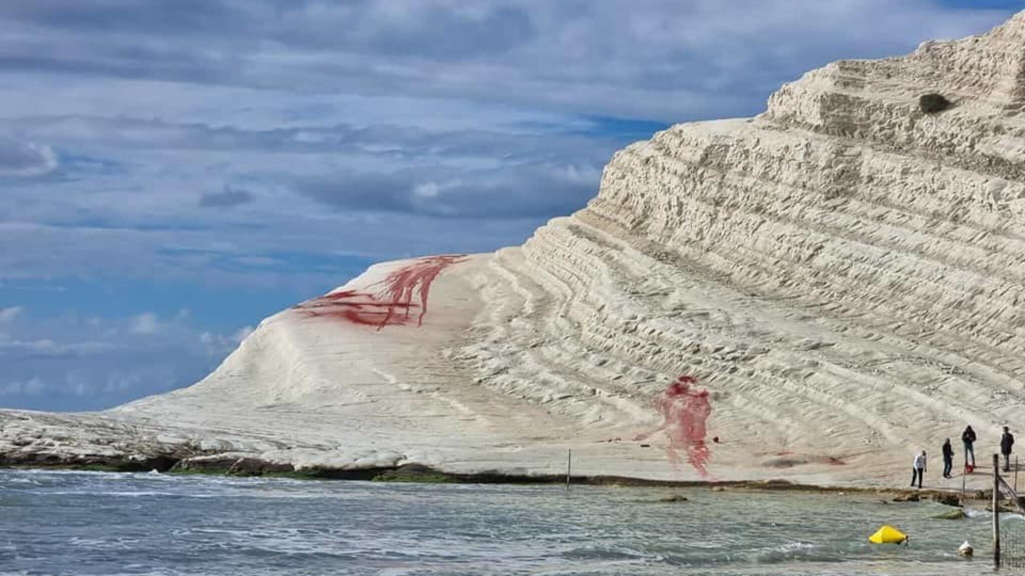 A famous Italian cliff was defaced with red powder by vandals