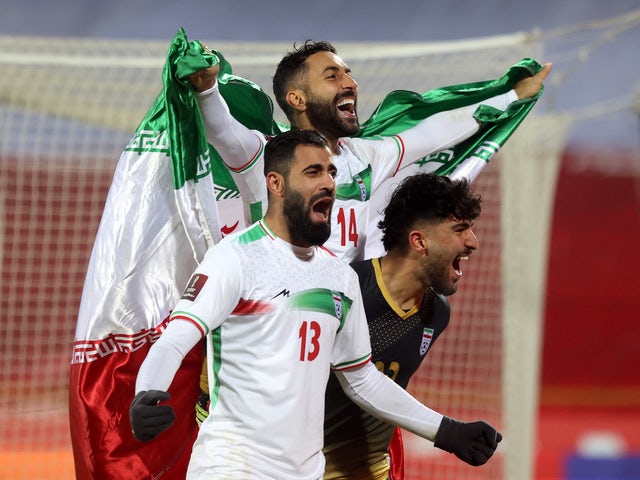 Iranian Saman Kaddous and Hossein Kinani celebrate after qualifying for the World Cup on January 27, 2022