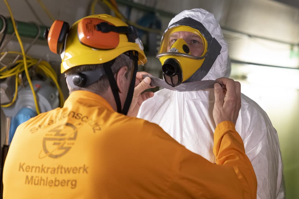 Workers in protective suits