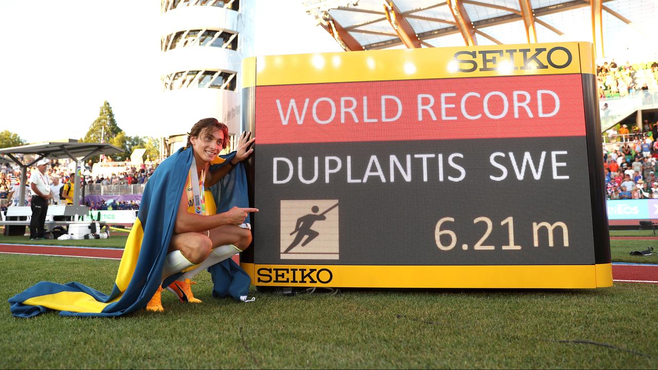 Armand Duplantis stands with the new world record.