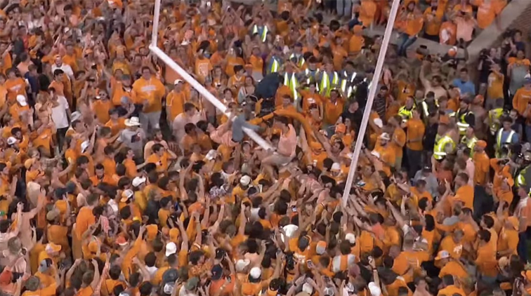 |  Total frenzy after an unexpected college football win: a massive field storm and theft of goal posts