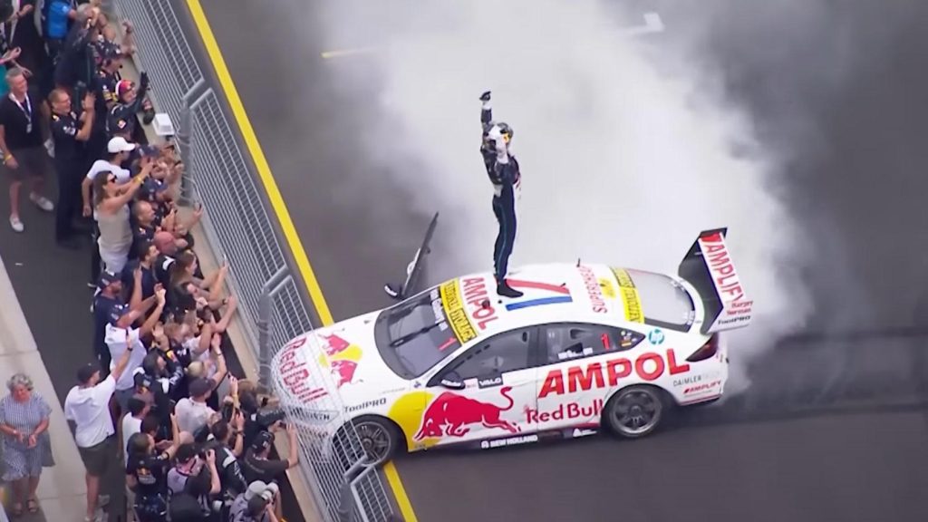 The driver gets out and jumps onto the roof during the burnout